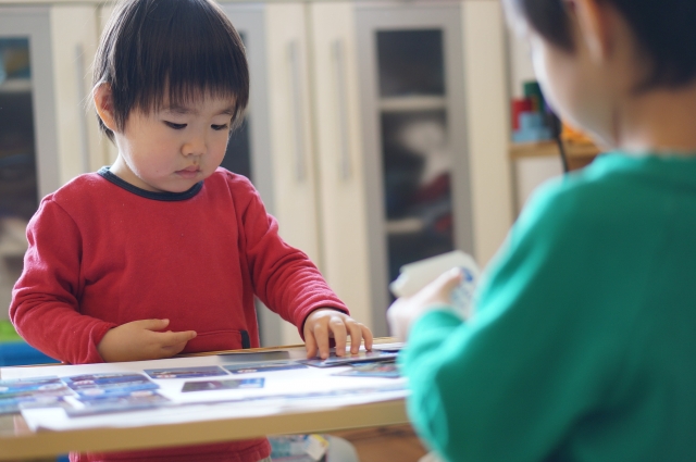 カードゲームで遊ぶ子供